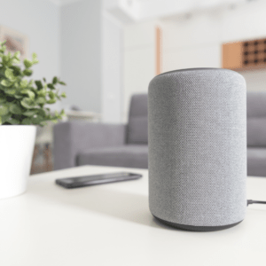A smart speaker sitting on a living room table 